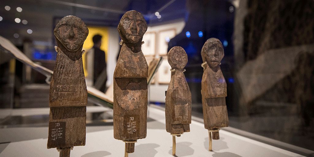 Ayurvedic medicine pills on a wooden table with herbs