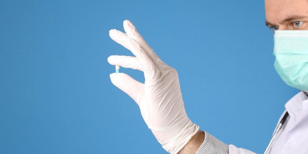 healthy person holding a capsule with a vibrant background